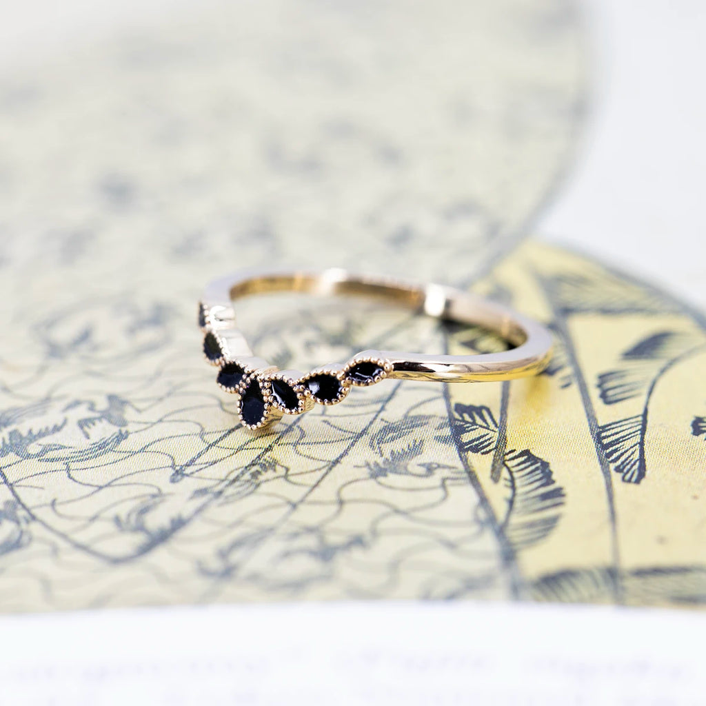 dainty yellow gold black enamel wedding band made by emily gill best bridal jewelry designer in canada v shape milgrain vintage style matching with engagement ring on multi color background
