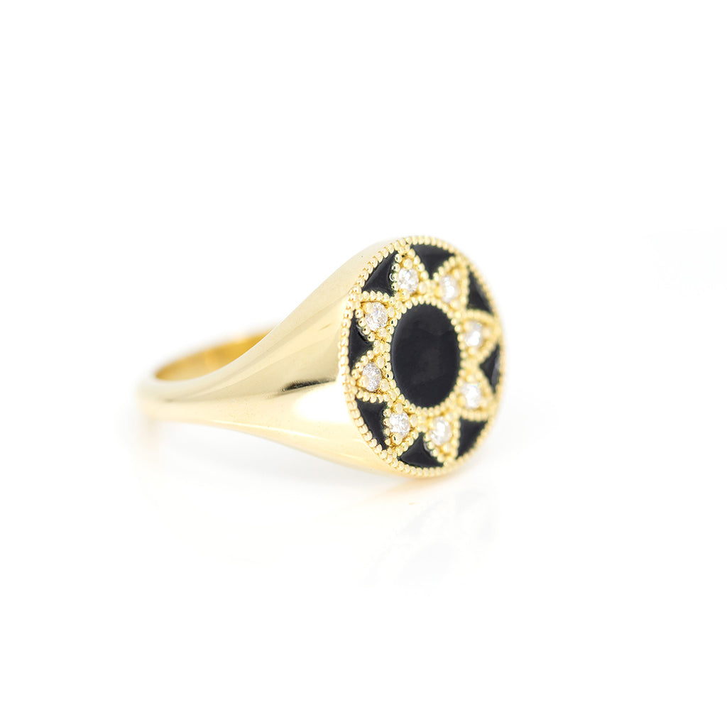 Side view of a yellow gold signet ring with black enamel and natural diamonds photographed on a white background. This fine jewelry piece was handcrafted in Toronto by independent jewelry designer Emily Gill and available exclusively at the best jewelry store in Montreal AND Canada, Ruby Mardi.