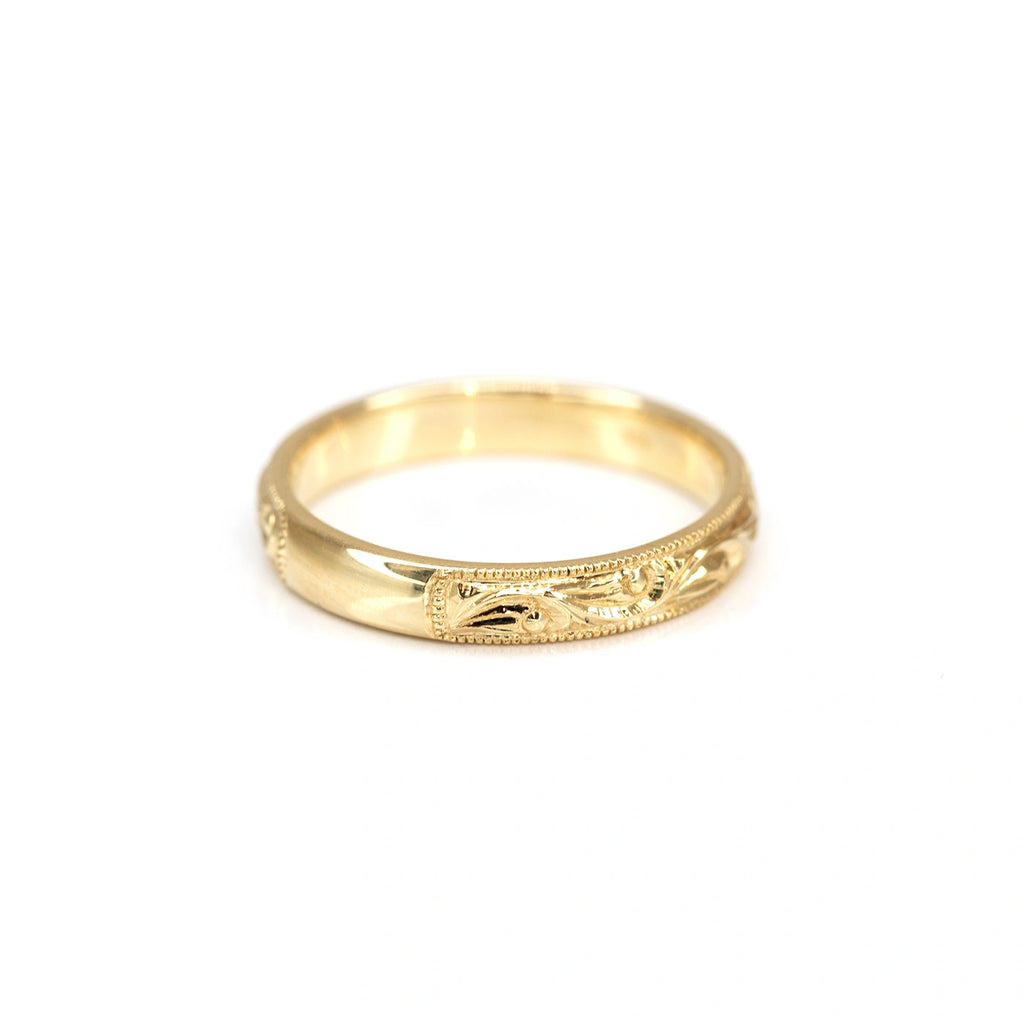 yellow gold engraved wedding band handmade by montreal finest jewelery designer Deborah Lavery engagagement ring specialist avialble at boutique ruby mardi jeweler in montreal little itlay on a white background