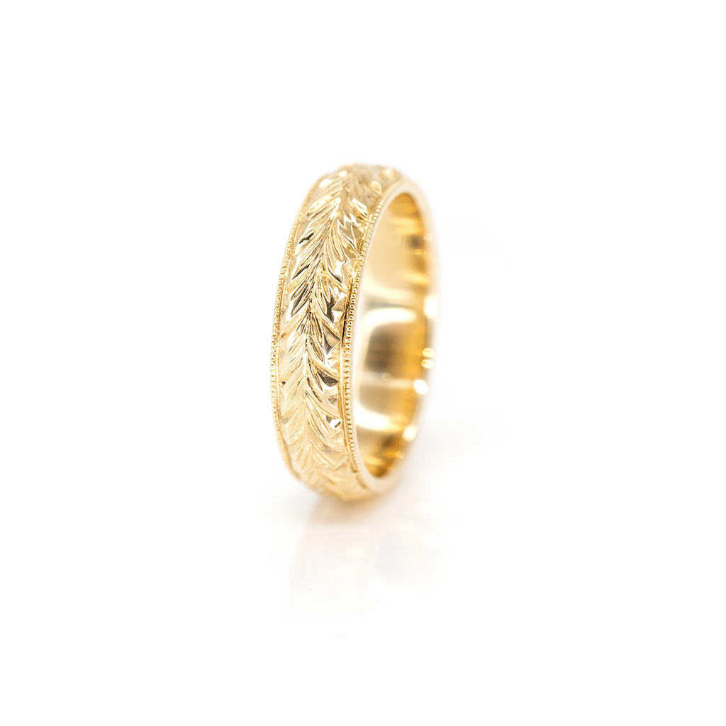 front view of gold wedding band enagement ring custom made in montreal by deborah lavery on a white background