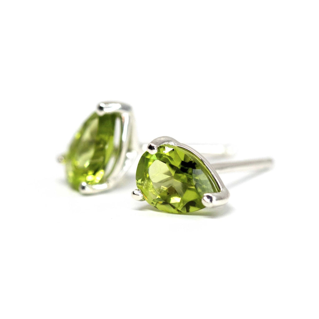 side view of custom made colored gemstone jewelry peridot silver stud earrings made by ruby mardi montreal little italy  jeweler on a white background