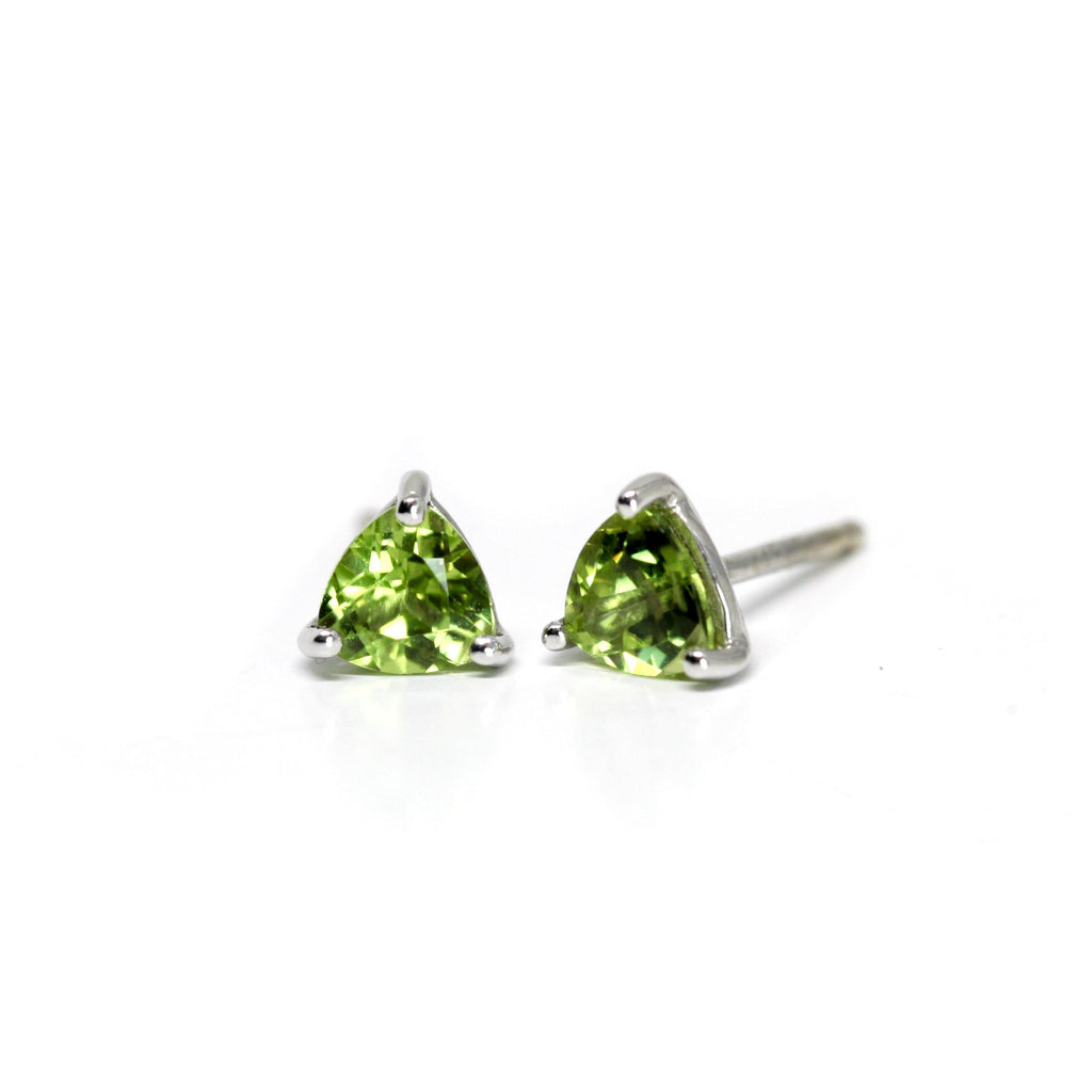 Peridot Earrings on a white background. Peridot gemstone stud silver earrings created by Ruby Mardi, a fine jewelry store in Montreal's Little Italy, close by Outremont, Rosemont, Villeray and Mile End districts. We specialize in engagement rings, gold jewelry, heirloom jewelry, bespoke, custom jewelry creation in Montreal. We can source ethical gemstones, natural diamonds, lab grown diamonds, Canadian Diamonds. We sell the work of the most talented Canadian jewelry designers.