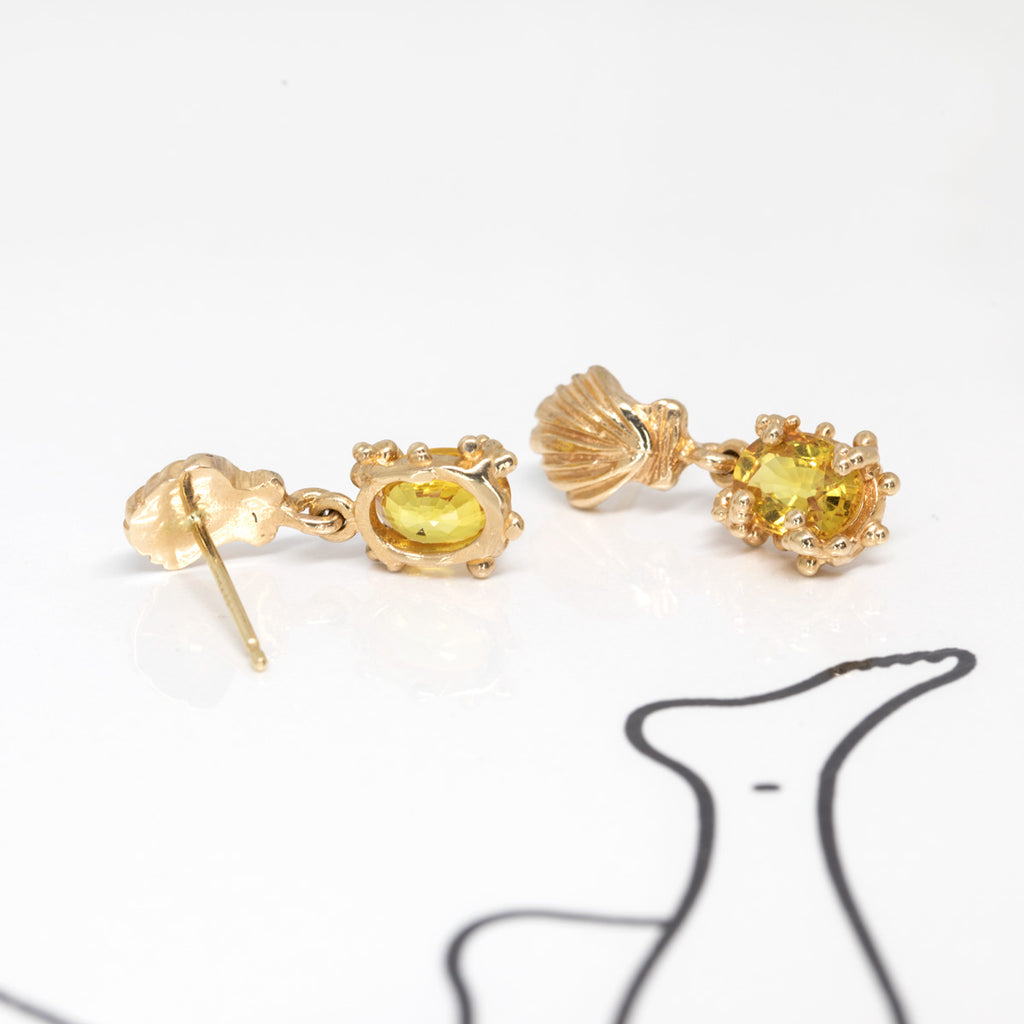 back view of yellow gold sapphire earrings made in canada by the jewelry designer meg lizabet on a white background