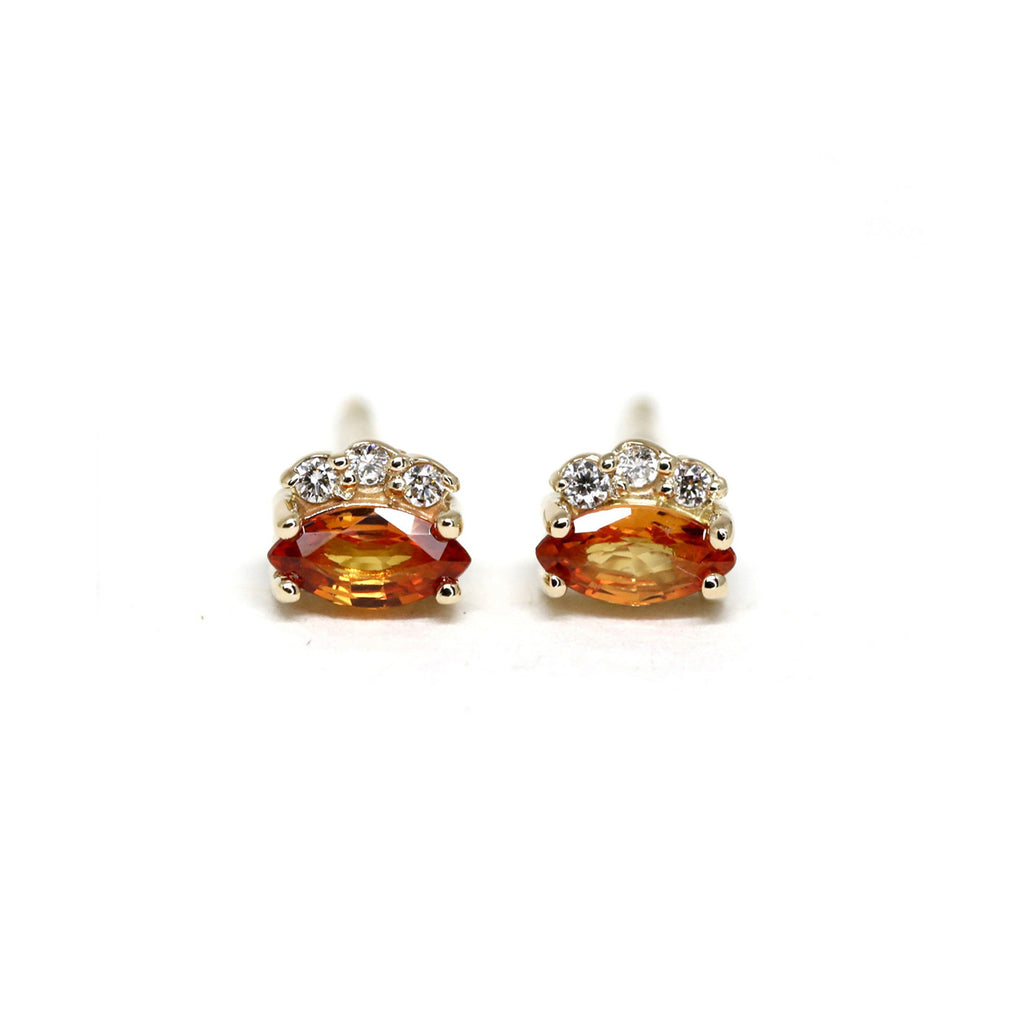 Orange Sapphire Earrings with 3 small diamonds on a white background. Sapphire gemstone stud gold earrings created by Ruby Mardi, a fine jewelry store in Montreal's Little Italy, close by Outremont, Rosemont, Villeray and Mile End districts. 