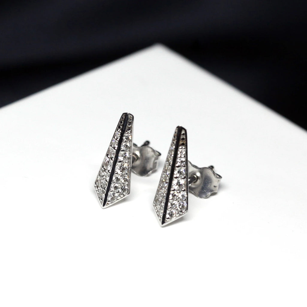 front view of lab grown diamond white gold earrings unisex edgy studs at the best jewelry store in montreal boutique ruby mardi on a white and black background
