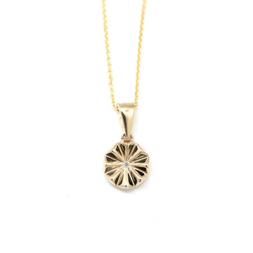 Yellow gold diamond pendant with a diamond handmade in Montreal by Ruby Mardi, seen on a white background.