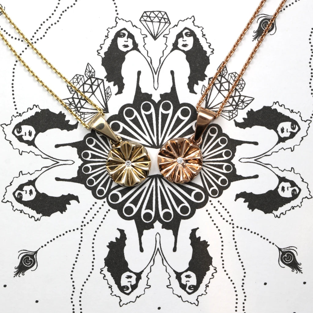 Psychedelic image showing ladies, diamonds and peacock feathers on which a yellow gold pendant and a rose gold pendant are shown. A small lab grown diamond is placed in the center of these delicate necklaces.