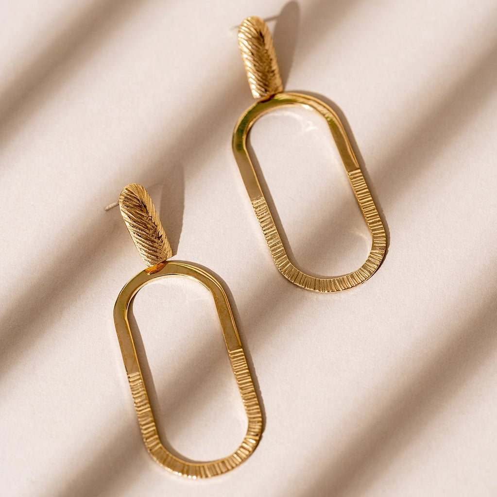 Big statement gold plated hoop earrings handmade in Montreal and available at local jewelry store Ruby Mardi.