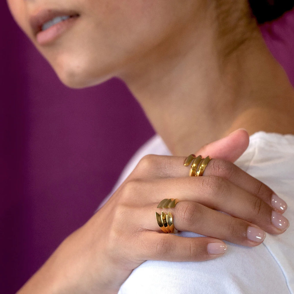girl wearing vermneil gold bold statement ring made by designer for jeweler ruby mardi montreal on a purple background