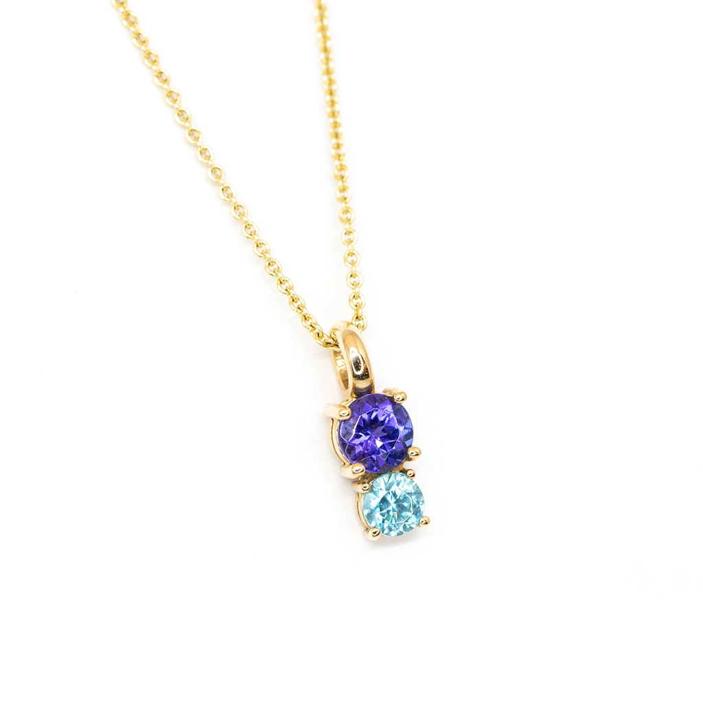 small round tanzaninte blue zircon gemstone yellow gold pendant and chain made in montreal by lico jewelry designer at boutique ruby mardi best canadian designer jewellery gallery in canada on white background