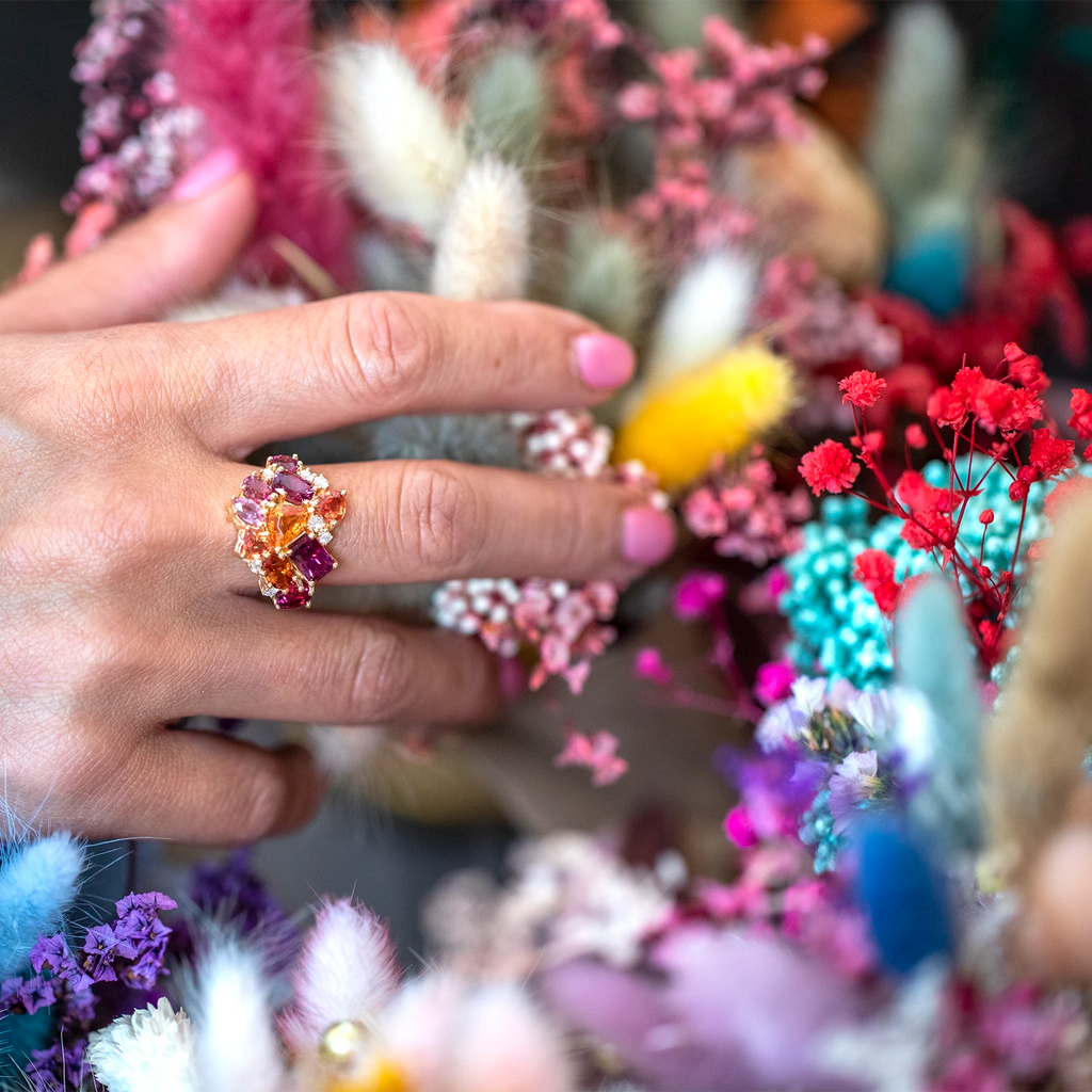 girl wearing a muli color custom made bridal engagement ring made by bena jewelry designer in montreal for ruby mardi jeweler little italy montreal holding flowers