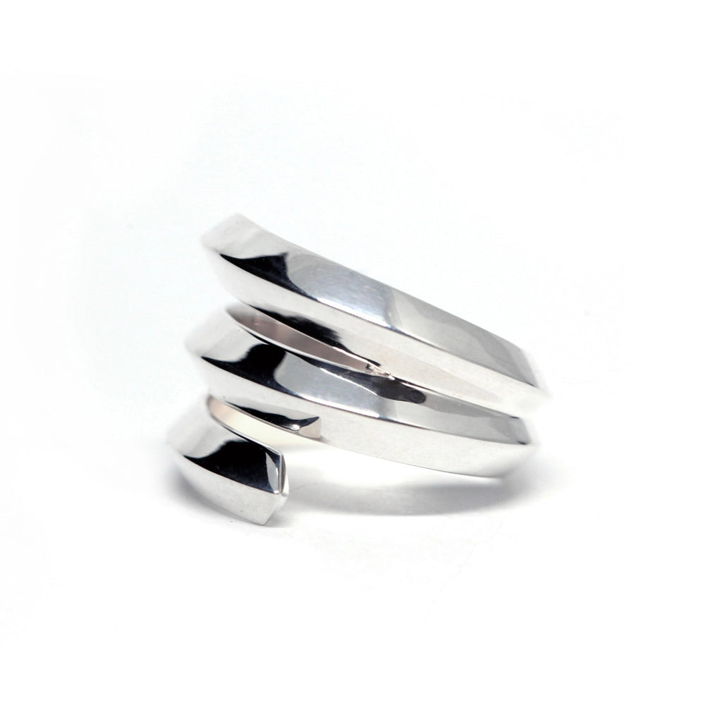 Embrace ring in sterling silver on a white background photographed in close-up. Ready-to-wear fashion jewelry available online or at our concept store in Montreal's Little Italy, along with the work of other talented jewelry designers.