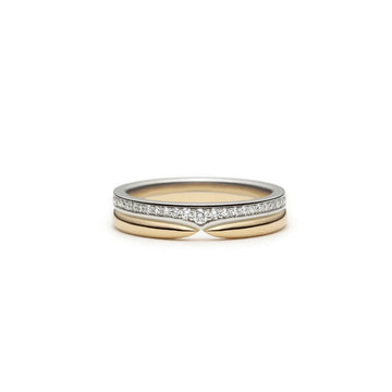 An edgy yet classic and elegant wedding band featuring a half-eternity of natural bright diamonds set on a white gold band, and a yellow band on top with a pinch center that makes it perfect to match with a solitaire engagement ring. This designer band is seen photographed on a white background.
