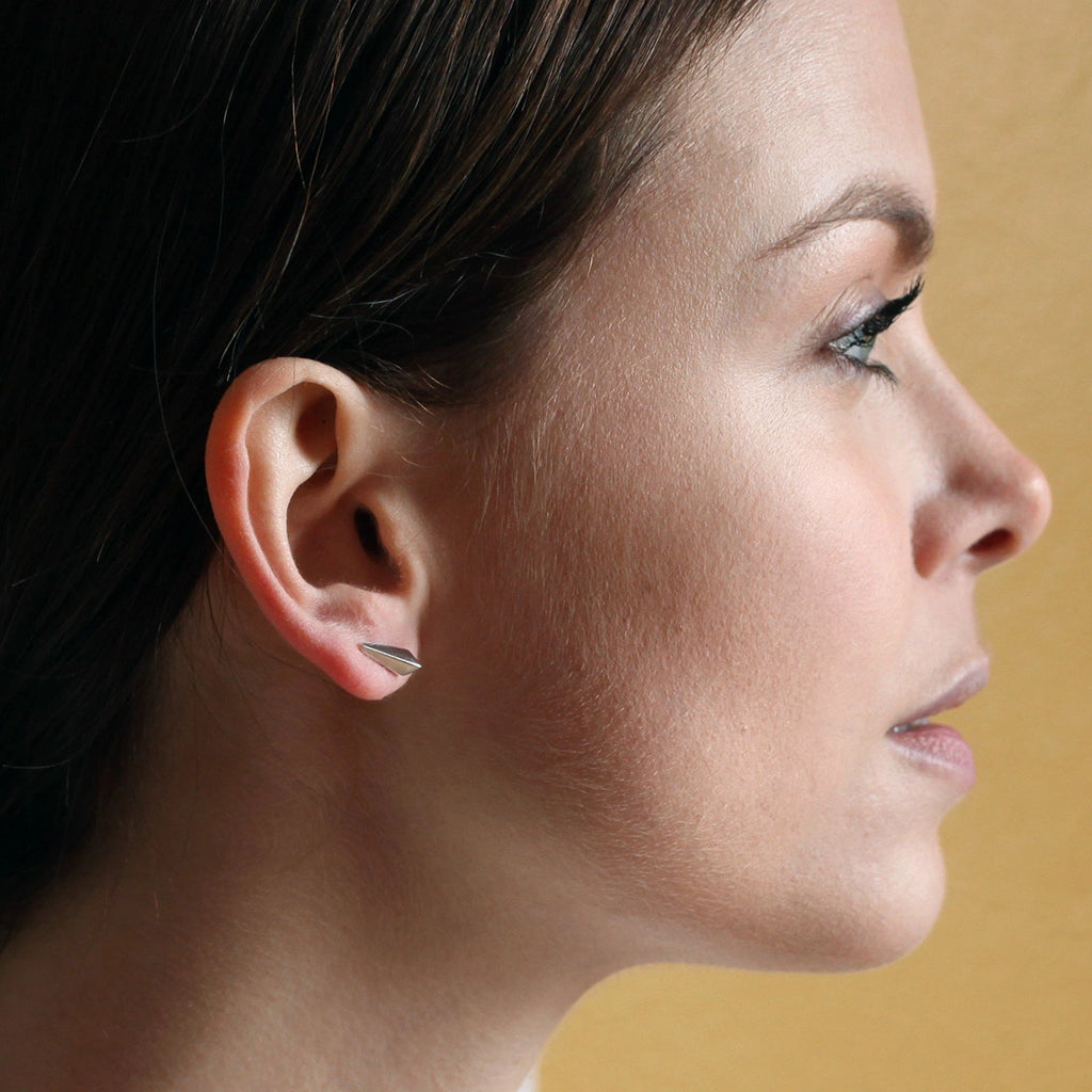 side view of girl's face with a silver edgy earrings made in montreal by jeweler ruby mardi