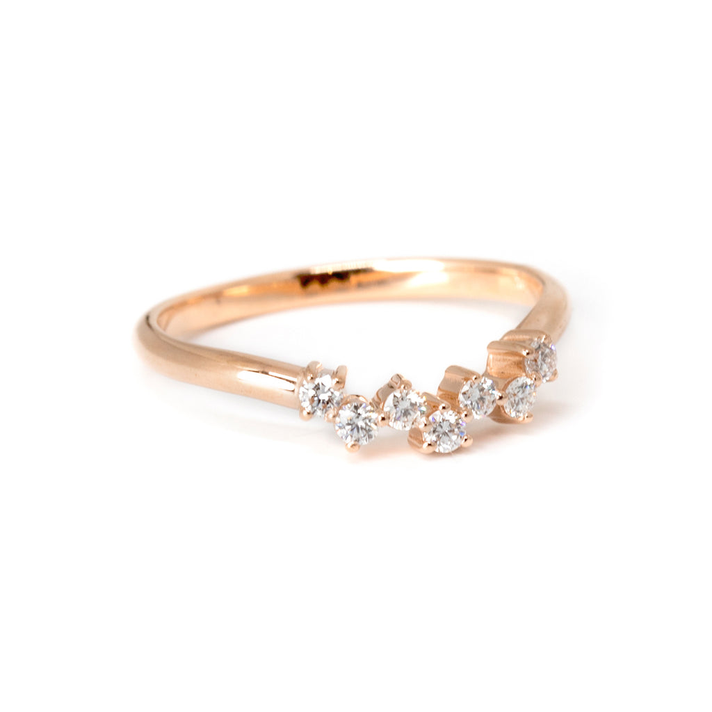 Side view of a rose gold wedding band with a cloud of seven extra billiant round diamonds.