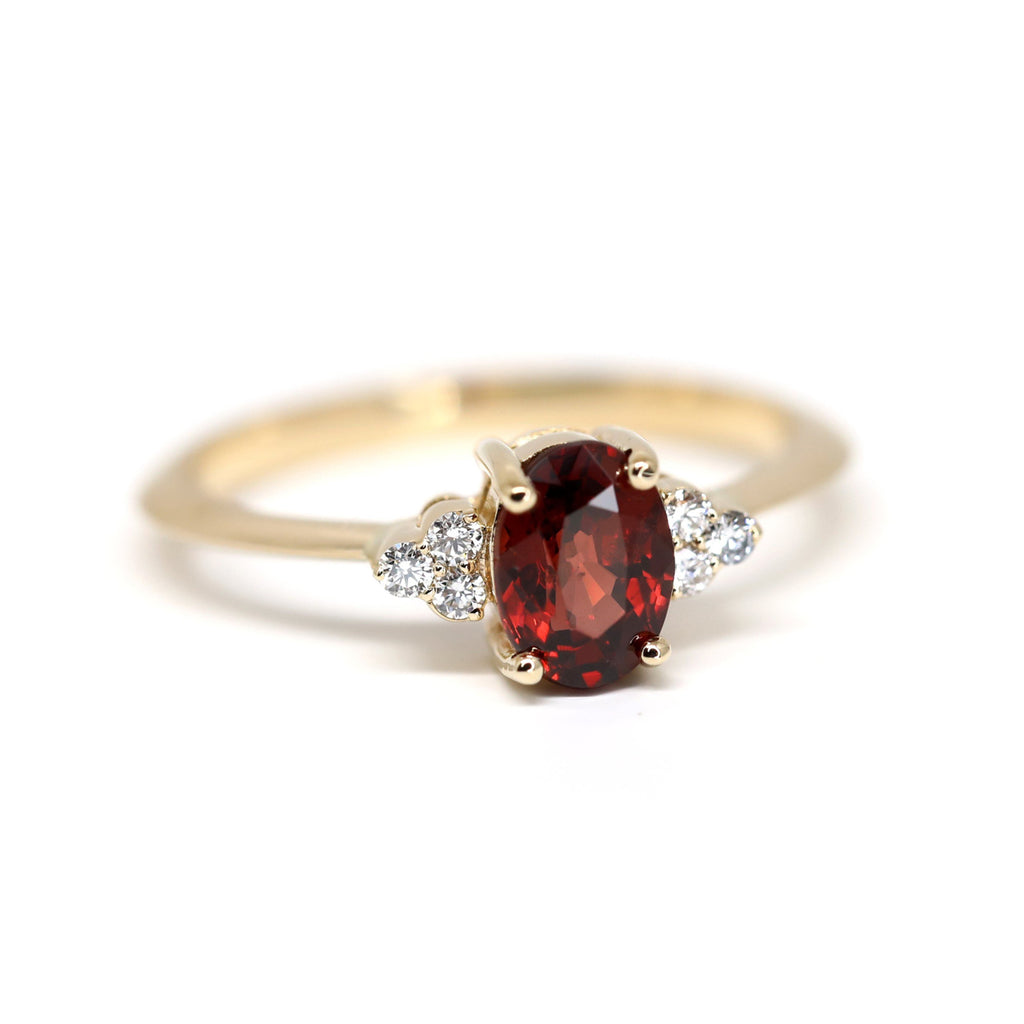 Handmade and sustainable engagement ring featuring a red garnet and six diamonds. It’s available at the only fine jewelry gallery in Montreal, Ruby Mardi. 