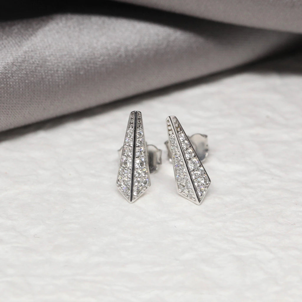 front view of lab grown diamond studs fine earrings custom made bespoke edgy jewelry in montreal on a grey background