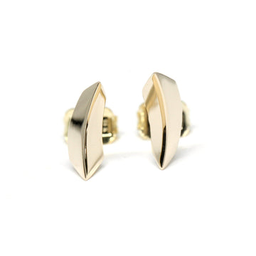 Edgy yellow gold unisex stud earrings by Montreal jewelry designer Bena Jewelry. Bold and modern earrings created for boutique Ruby Mardi in Canada. Minimalist yet statement jewelry, photographed against a white background.