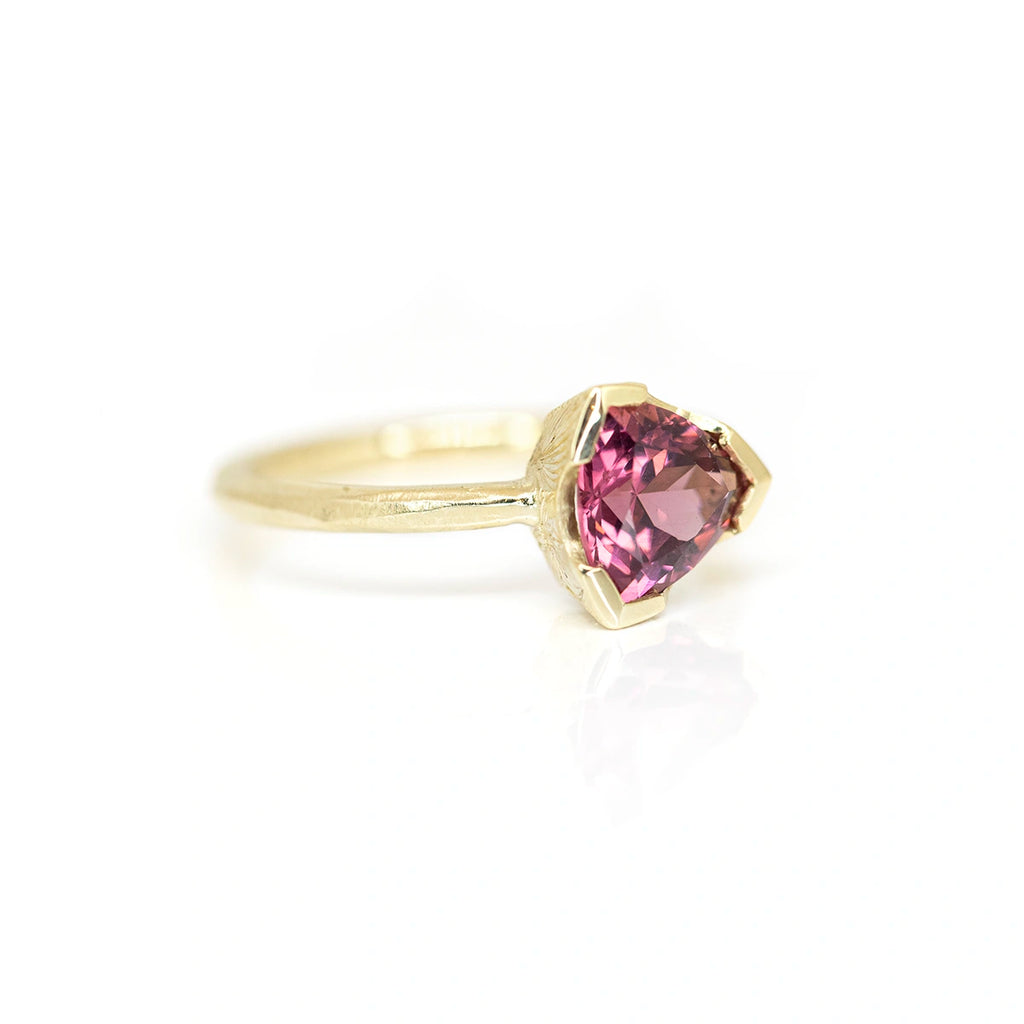 side view of Sheena Purcell red garnet gemstone yellow gold ring custom made in montreal fine edgy desginer jewelry on white background