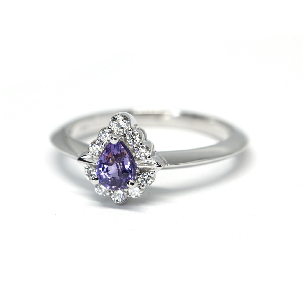 artisan designer custom made bridal ring with a pear shape purple sapphire and diamond halo ring made in montreal by ruby mardi jeweller on a white background