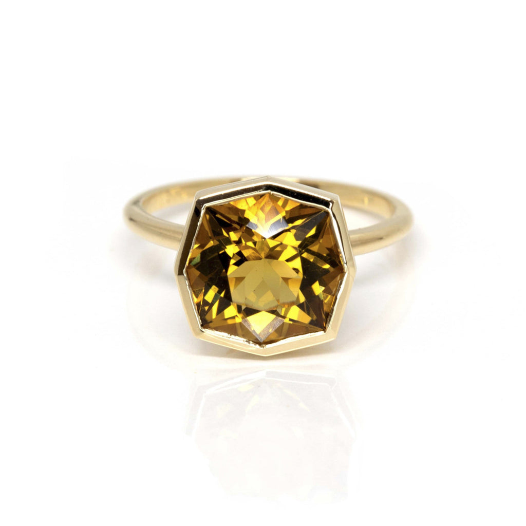 Product photography of a beautiful ring in 14k yellow gold featuring a huge fancy shape citrine, by designer Bena Jewelry. Find the most exquisite designer jewelry at Ruby Mardi, a fine jewelry store in Montreal that presents the work of the most talented Canadian jewelry designers. Custom jewelry services also offered.