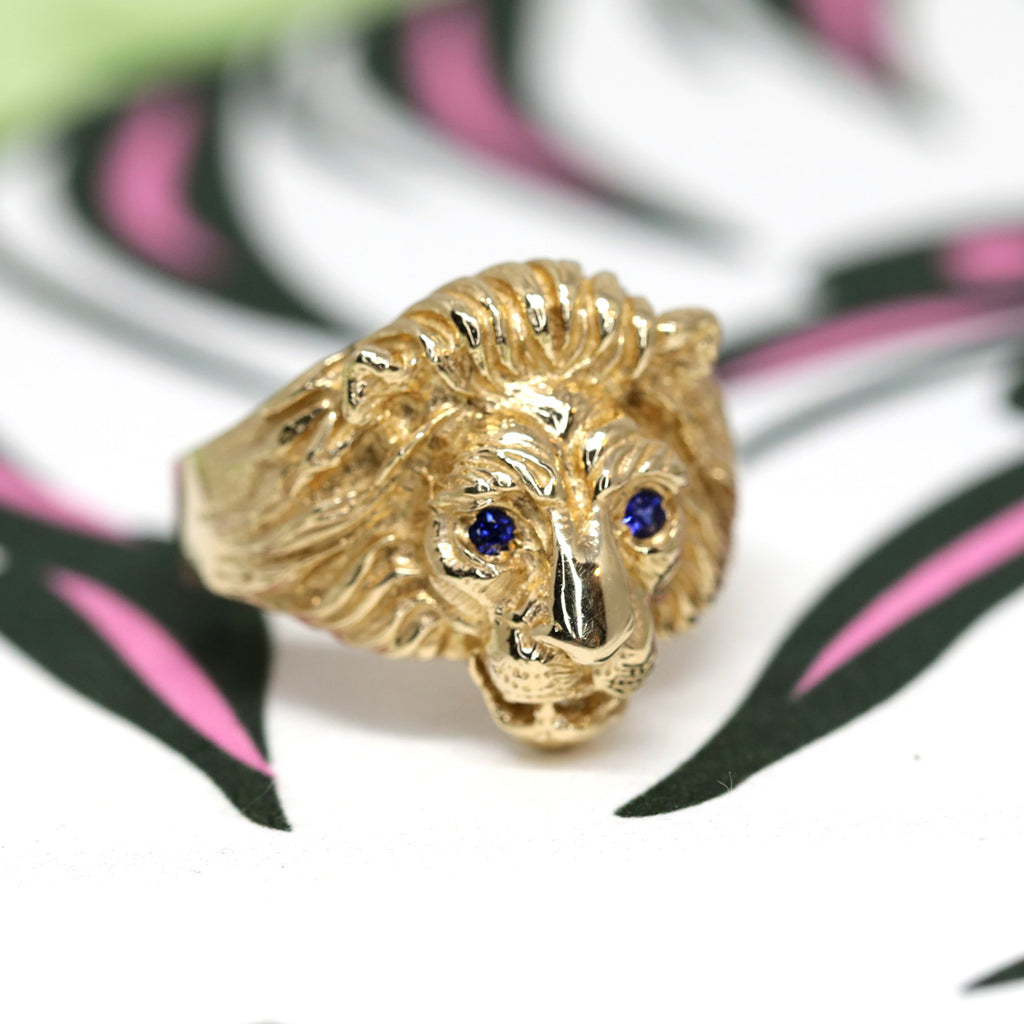 Close up of a fine jewel on a funky background: Gold lion head ring with blue sapphire eyes by jewellery designer Cecilia Lico. Her creations are available at Ruby Mardi, a luxury jewellery store located in Montreal's Little Italy.