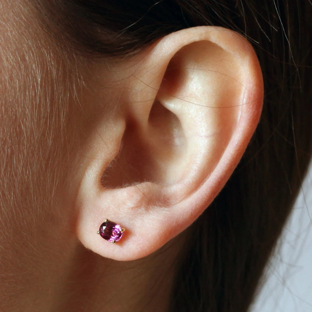 girl wearing oval shape bright purple garnet stud earrings colored fine bena jewelry design at jeweler boutique ruby mardi