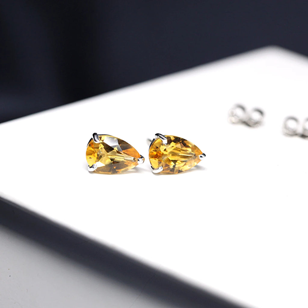 Side view of pear shape citrine quartz natural untreated gemstone stud earrings by Bena Jewelry Montreal Fine Jewerly Designer for Ruby Mardi Boutique Jeweler Little Italy Montreal Made in Canada