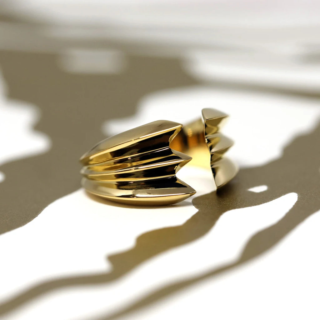 side view of vermeil gold bold ring canadian designer fine jewellery on golden and white background