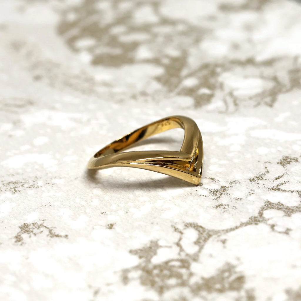 edgy unisex yellow gold vermeil edgy bena jewelry ring made in montreal on a marble background