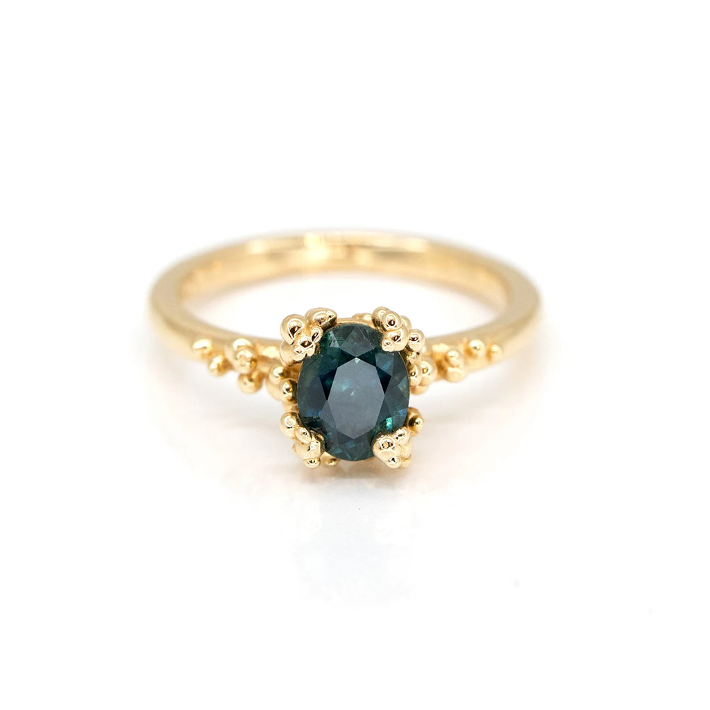 montana sapphire yellow gold oval shape sapphire custom made designer engagement ring by Meg Lizabet Jewellery at the best jewelry store in montreal boutique ruby mardi on a white background