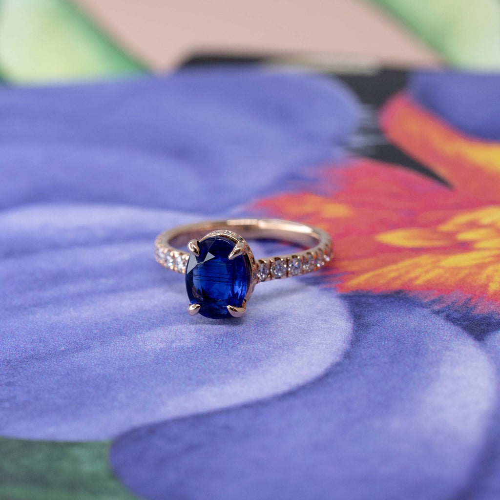 lico jewelry montreal designer iolite bridal engagement ring photographed on a flowery background. Classic engagement ring with a hidden diamond halo