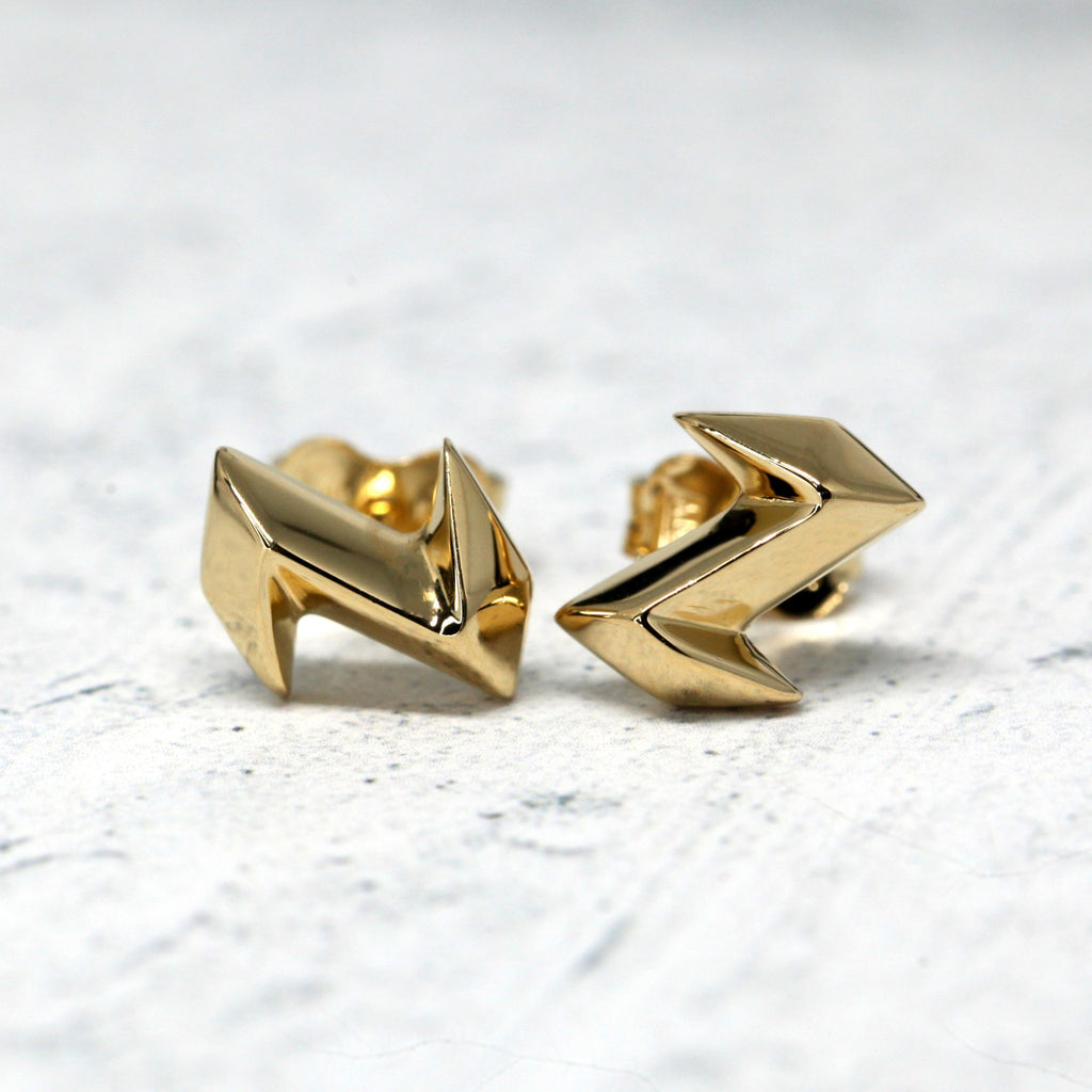 front view of yellow gold vermeil edgy stud earrings custom made in montreal by bena jewelry at the best jeweler in canada boutique ruby mardi on a grey background