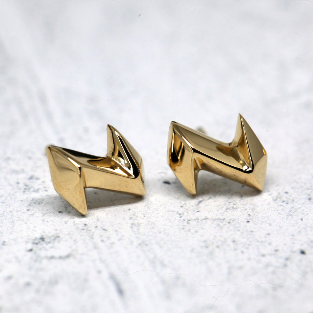front view of yellow gold vermeil stud edgy earrings designer made in canada by bena jewelry fine jeweler in montreal at the best jewelry store boutique ruby mardi jewellery gallery on grey background with balck points