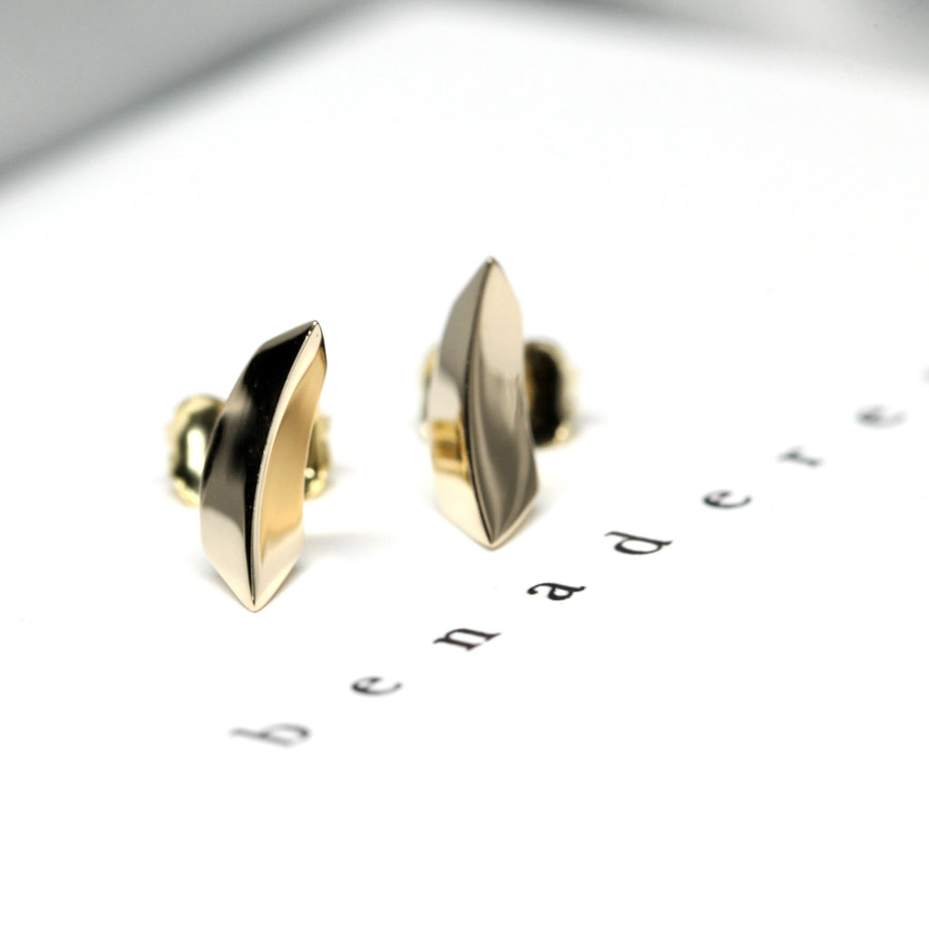 edgy stud earrings in yellow gold custom made by bena jewelry in montreal for boutique ruby mardi canadian jewellery designer gallery and fine jeweler in little itlay on a white background