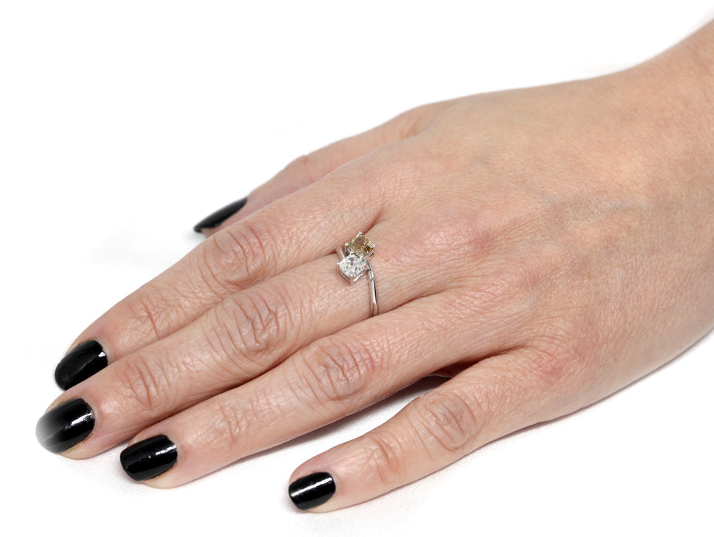 girl wearing a toi et moi cushion cut brown diamond and white icy montreal bridal ring for ruby mardi jewellery on a white background