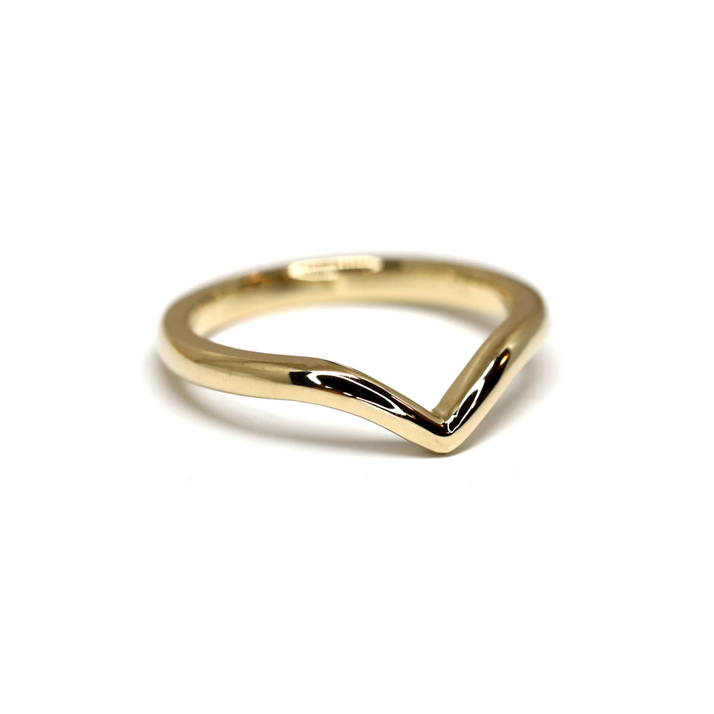 Simple 14k yellow gold crown wedding band on a white background handmade by Yuliya Chorna in Toronto.