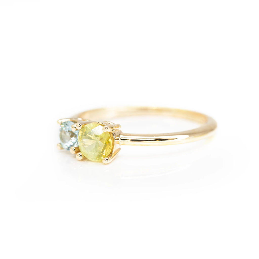 side view of yellow sapphire round gemstone and topaz yellow gold minimlist lico jewelry engagement ring custom made in montreal on white background