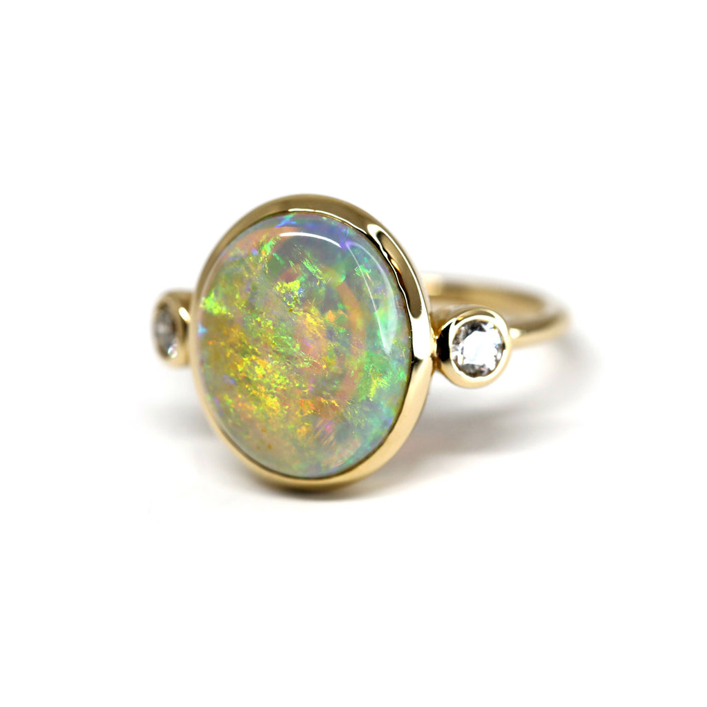 Big Opal yellow gold statement ring with two small diamonds, by designer Lico Jewelry. Ruby Mardi focuses on Canadian young inventive brands with expertise and know-how, custom jewelry and engagement rings.