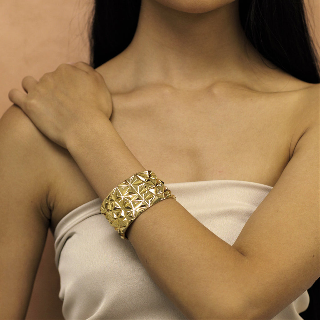 Girl wearing statement gold plated bracelet 