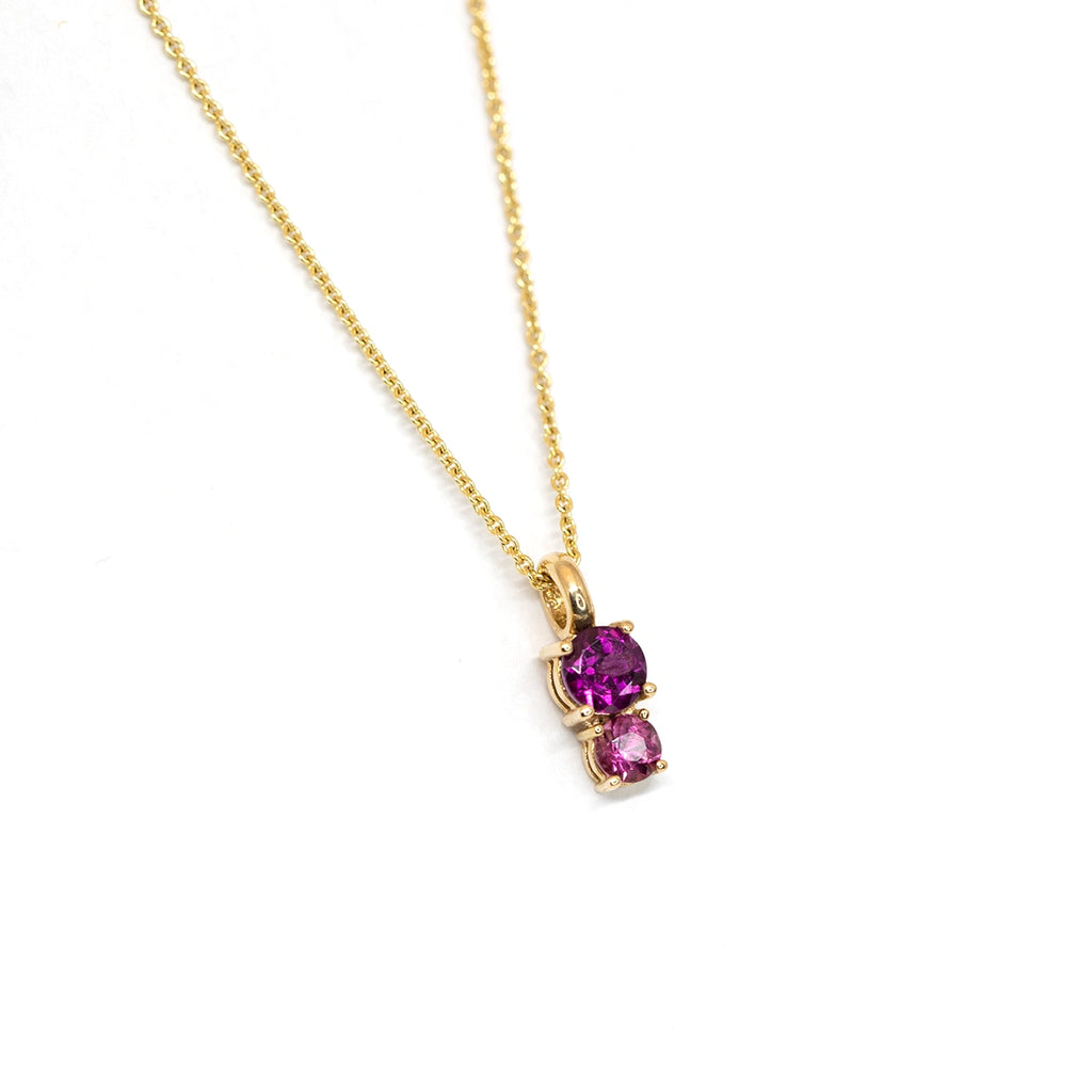 side view of purple and pink tourmaline toi et moi pendant in yellow gold custom made in montreal by lico jewelry finest designer jeweler ruby mardi on white background