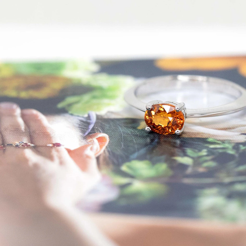 side view of orange garnet spessartite gemstone white gold minimalist engagement ring custom made colored gemstone bridal jewels by boutique ruby mardi montreal best jeweler