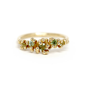 green sapphire yellow gold artisan designer ring meg lizabet for the jewellery boutique ruby mardi montreal jeweller in a white background