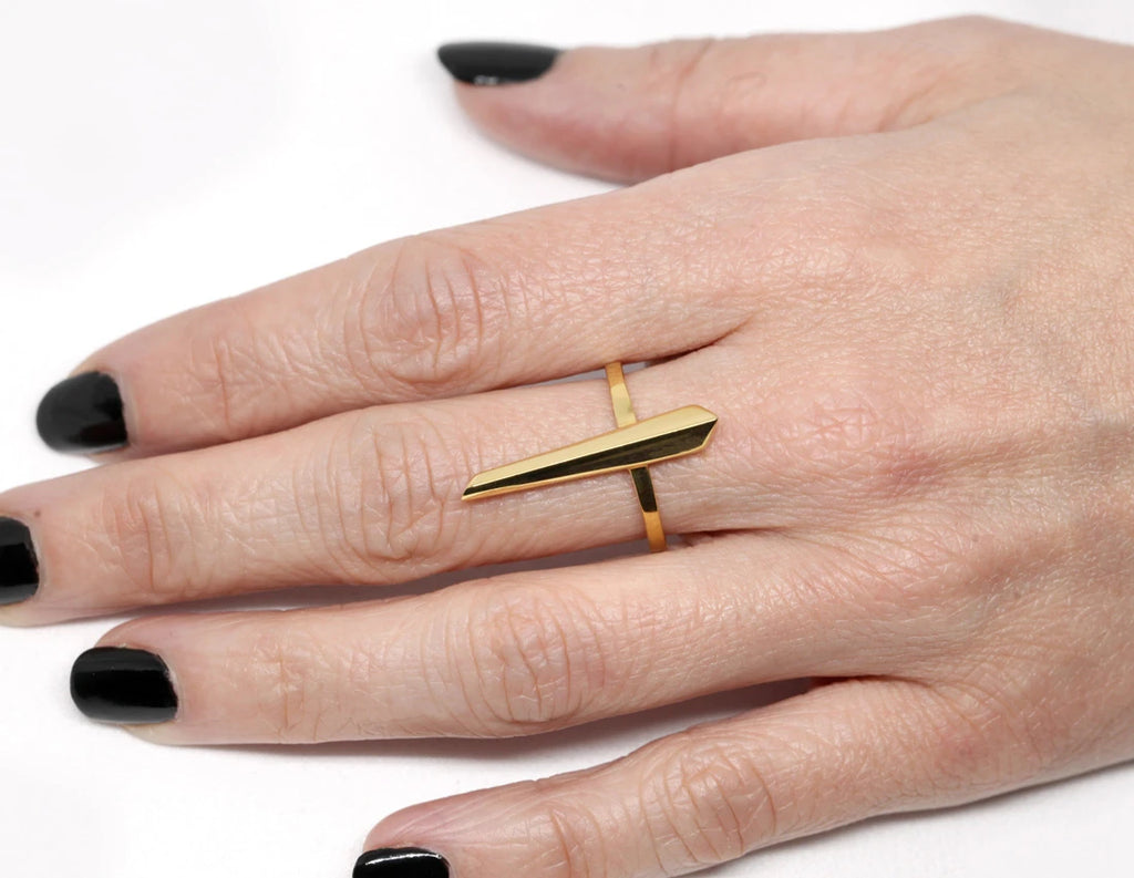 Peak ring in gold vermeil on a hand and photographed in close-up. Ready-to-wear fashion jewelry available online or at our concept store in Montreal's Little Italy, along with the work of other talented jewelry designers.