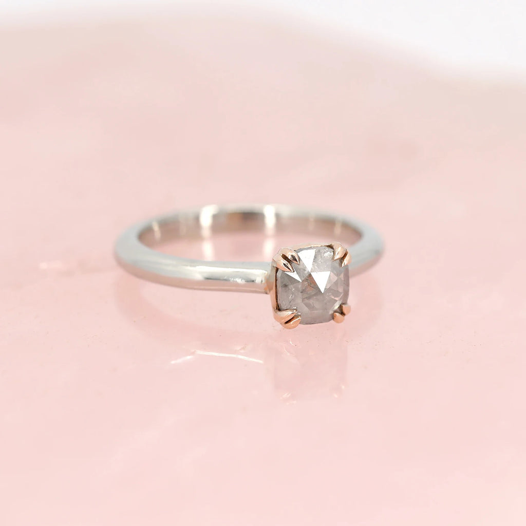 side view of white and rose gold bridal engagement ring custom made in montreal ab boutique ruby mardi for Arsaeus designs salt and pepper natural diamond specialist on pink background