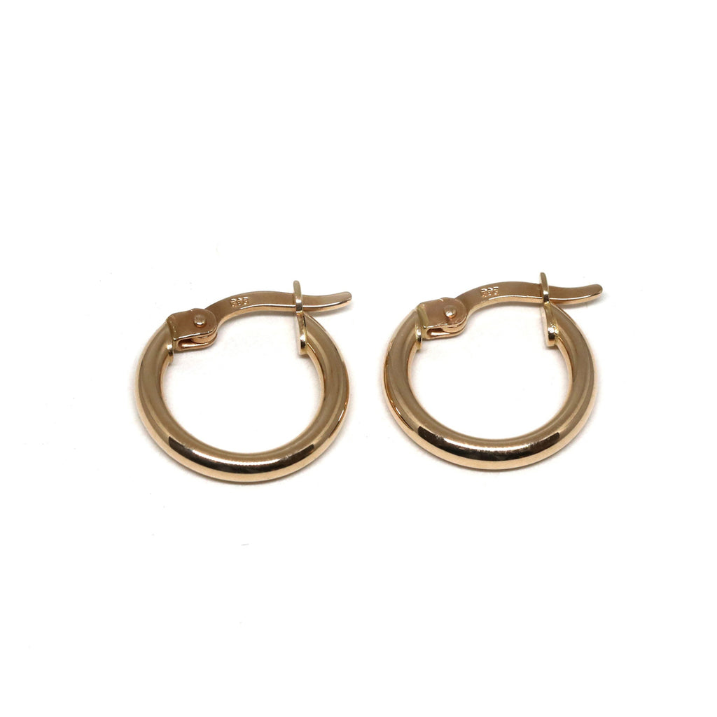Small 10k rose gold hoop huggie earrings on a white background. Ruby Mardi offers timeless jewelry classics that you will love to wear for any occasion. We also offer One-of-a-kind designer fine jewelry in Montreal. Find gemstone earrings, statement rings, engagement rings, right hand rings and more at our jewelry store in Little Italy. We also offer custom jewelry services.