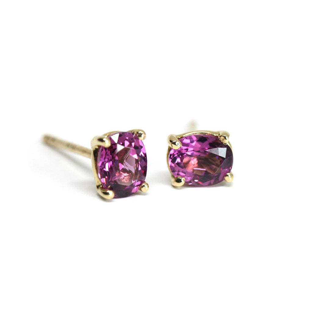 front view of oval pruple gemstone gold stud earings made in montreal rhodolite garnet bena jewlery on a white background