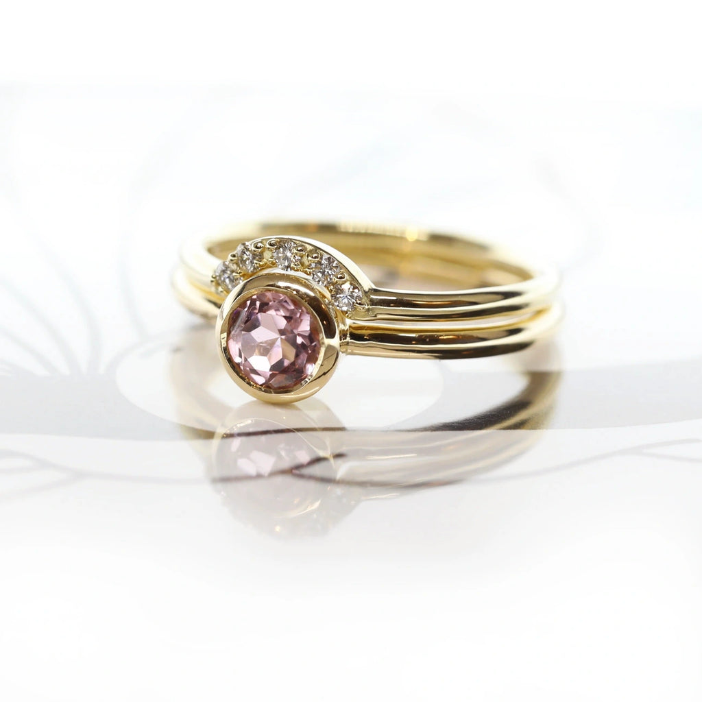 pink tourmaline gold ring and diamond matching band custom made in montreal by sheena for the jeweler ruby mardi on a white background