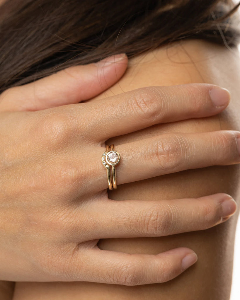woman's hand wearing a ring with a pink colored tourmaline with a diamond bangle made by jewelry designer sheena for the boutique jeweler ruby mardi montreal little italy