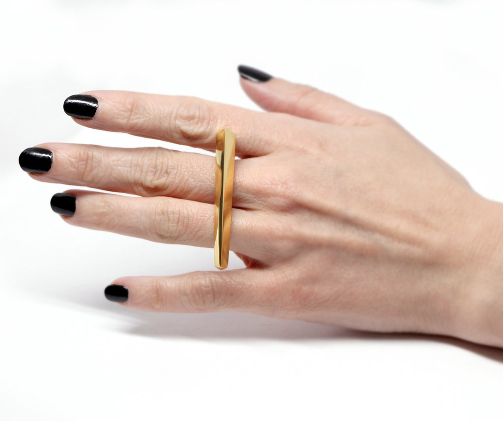 Punch Ring by Bena Jewelry, a two-finger ring worn by a lady and photographed in close-up. Ready-to-wear fashion jewelry available online or in Montreal's Little Italy.